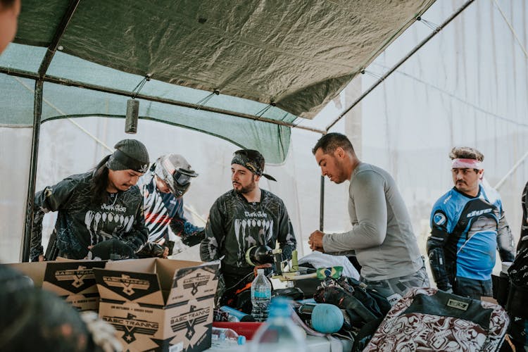 Group Of Men Preparing For A Game Of Paintball