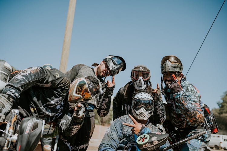 Group Of Men Posing After A Game Of Paintball