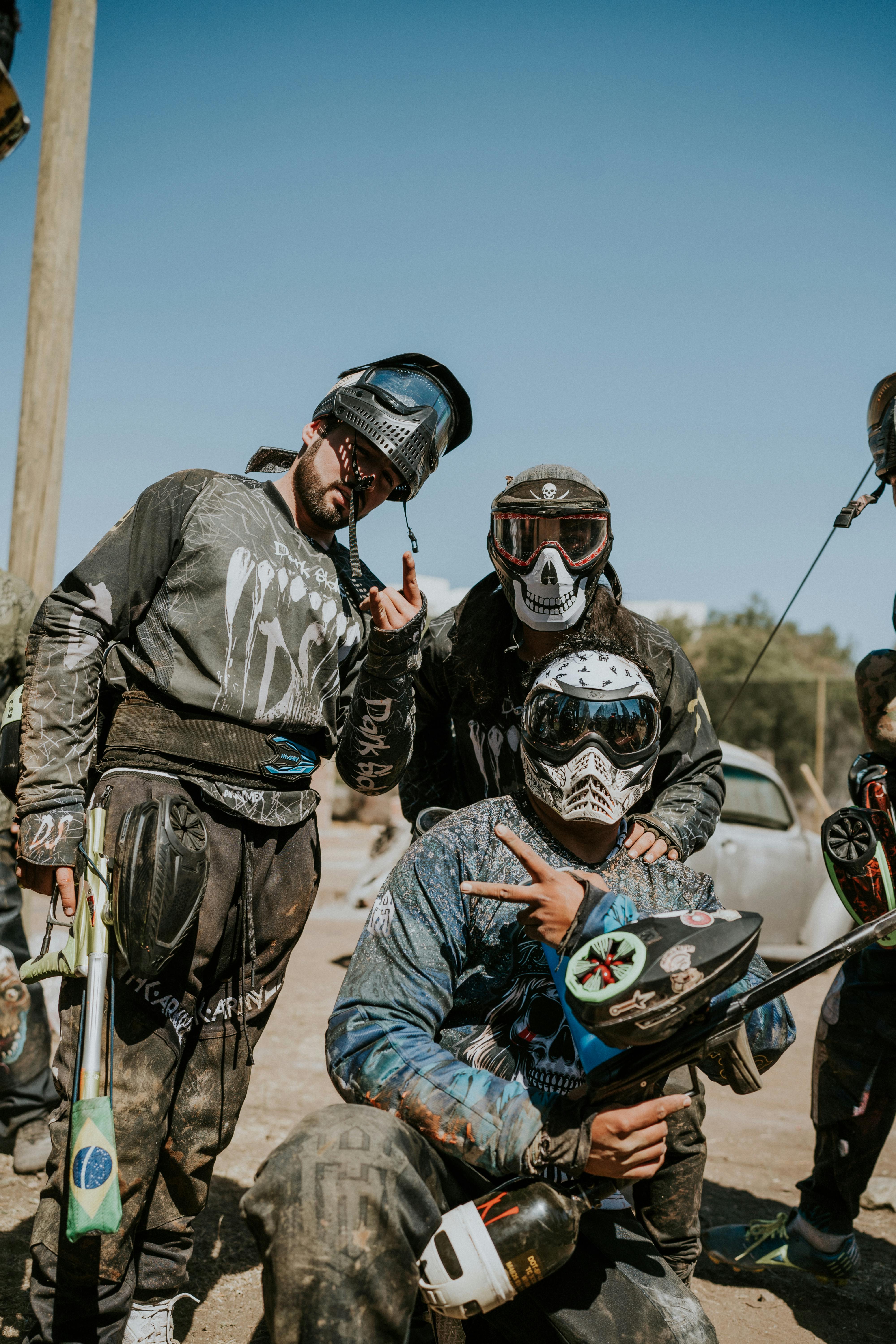 A group of paintball players wearing protective gear posing before a game. Outdoors setting. Prescription Goggle Inserts - A group of paintball players wearing protective gear posing before a game. Outdoors setting.