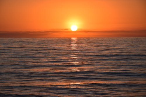 Безкоштовне стокове фото на тему «жовте небо, Захід сонця, море»