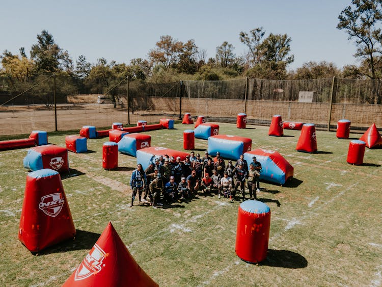 Group Of Men Posing After A Game Of Paintball