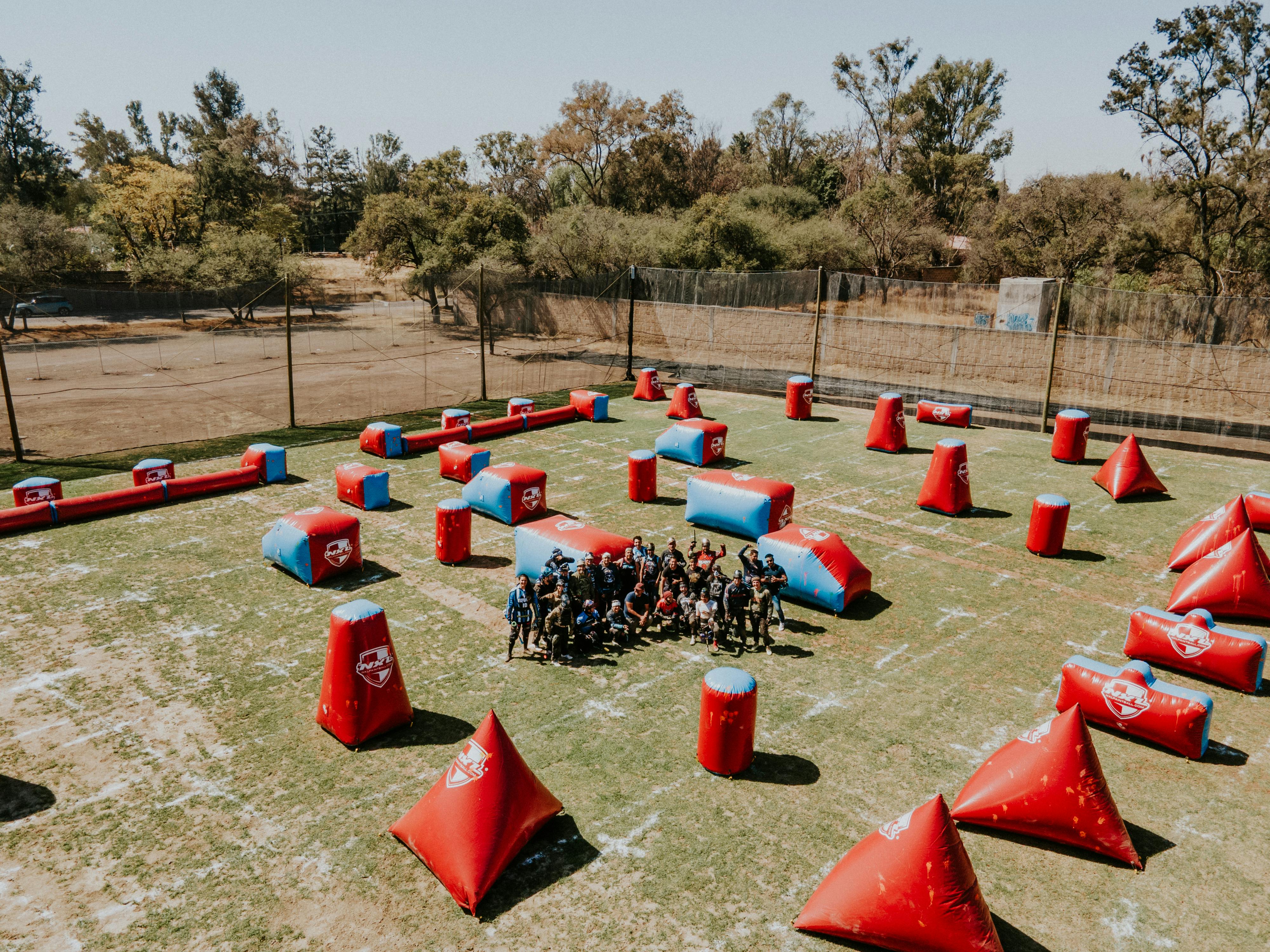 Paintball group playing on a sunny day in León, Mexico. Vibrant inflatable barriers fill the field. Prescription Goggle Inserts - Paintball group playing on a sunny day in León, Mexico. Vibrant inflatable barriers fill the field.