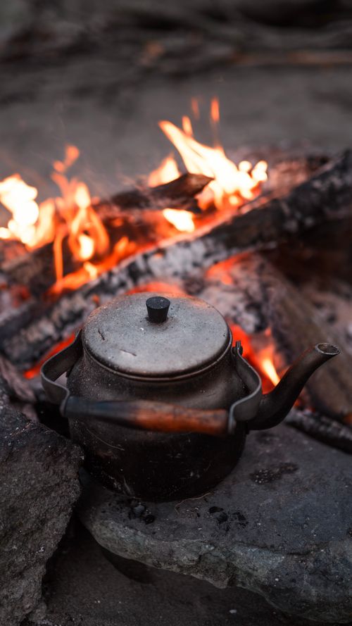 Free Vintage kettle heating by a campfire in Arhavi, Türkiye captured in a vertical shot. Stock Photo