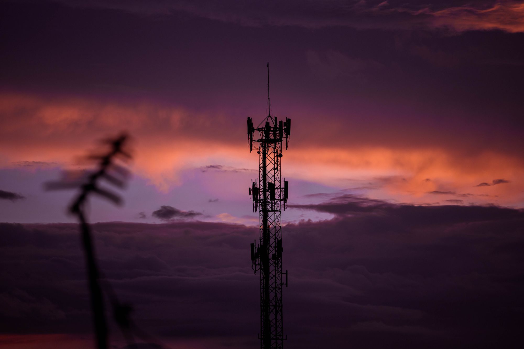 Stunning cell tower silhouette against a colorful twilight sky, reflecting modern communication.