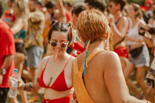 Free Cheerful crowd celebrating outdoors with music and dance. Perfect summer festival vibe. Stock Photo