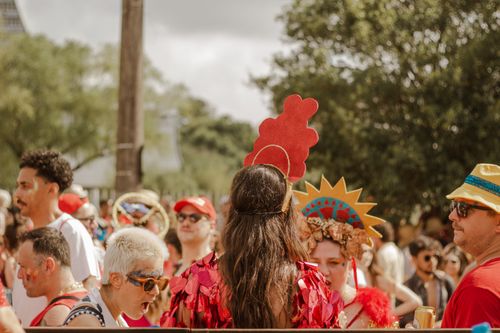 Free A lively outdoor festival scene featuring people in colorful costumes enjoying a sunny day. Stock Photo