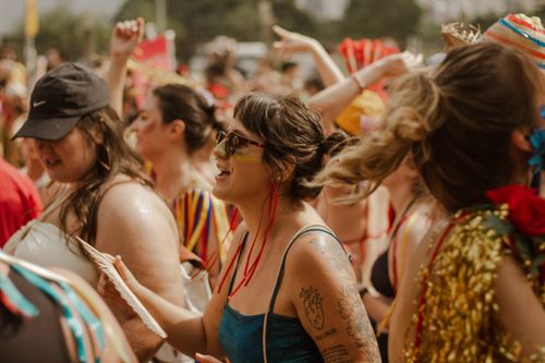 Free Joyful crowd of women celebrating at a vibrant summer festival outdoors, full of colorful outfits and energy. Stock Photo
