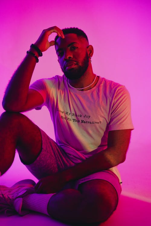 Man in T-shirt Sitting and Posing