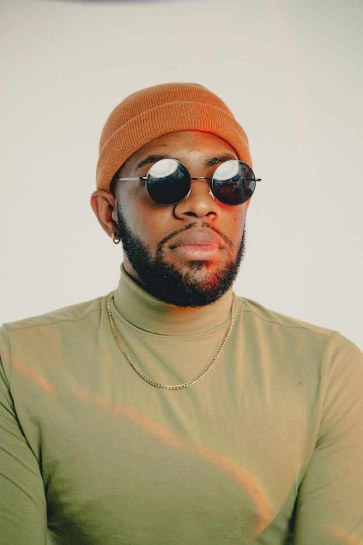 Young Bearded Man In Beanie Hat And Sunglasses In Studio