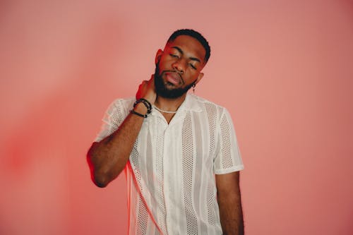 Young Bearded Man Posing on Pink Studio Background