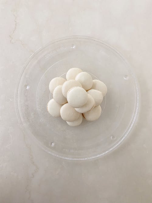 Stacked of White Macarons on a Glass Plate