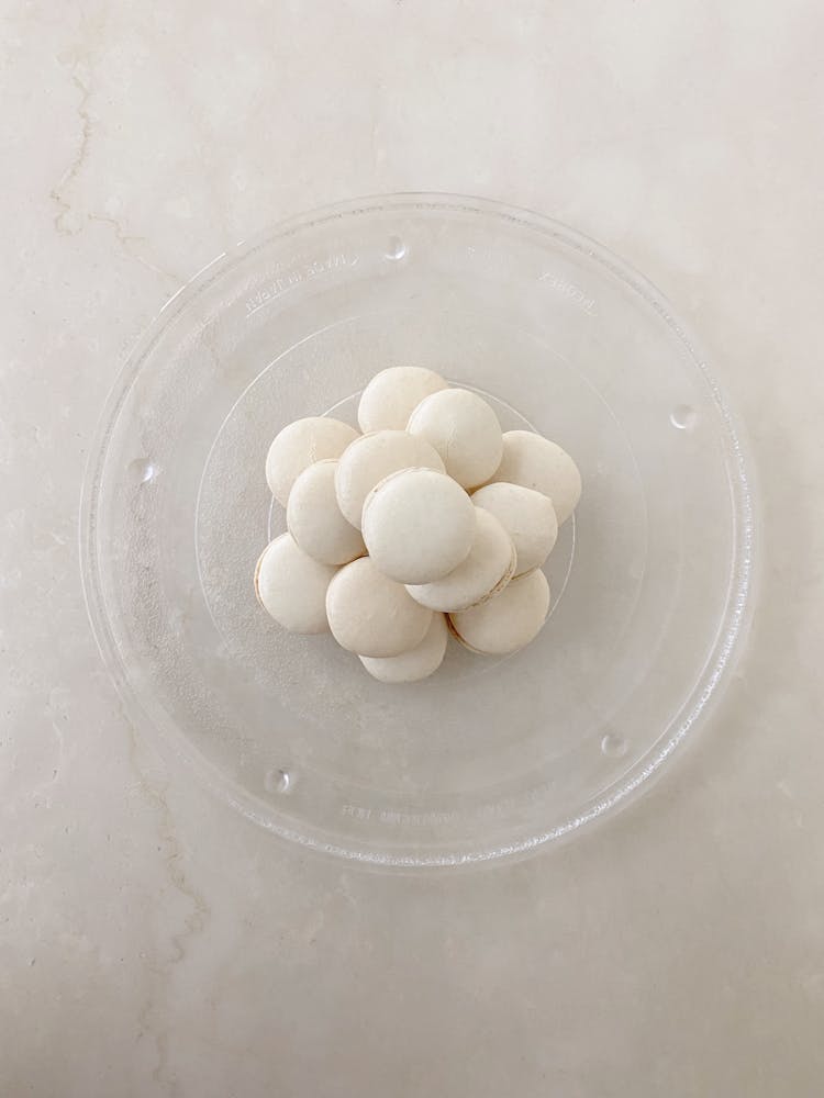 Stacked Of White Macarons On A Glass Plate