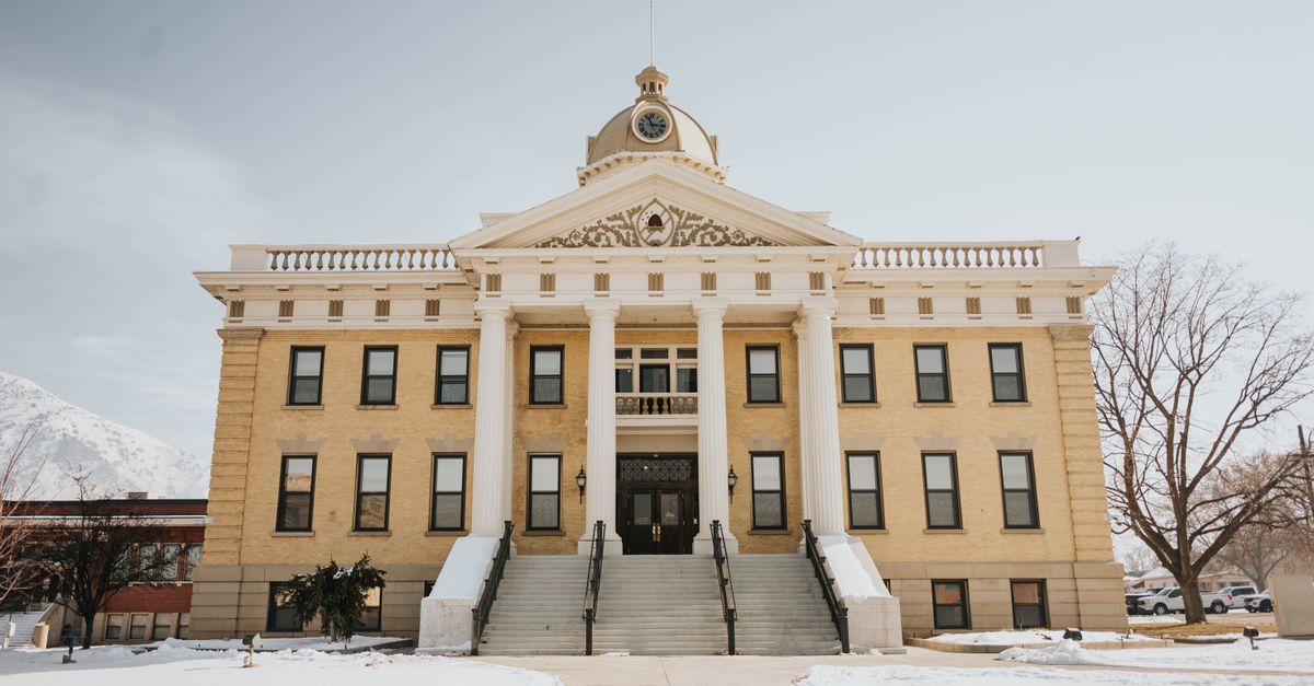 A prominent historic building in Brigham City, Utah, covered in snow during winter.
