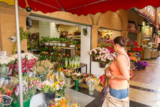 Woman checking floral arrangements at a lively flower market with diverse colorful blooms.