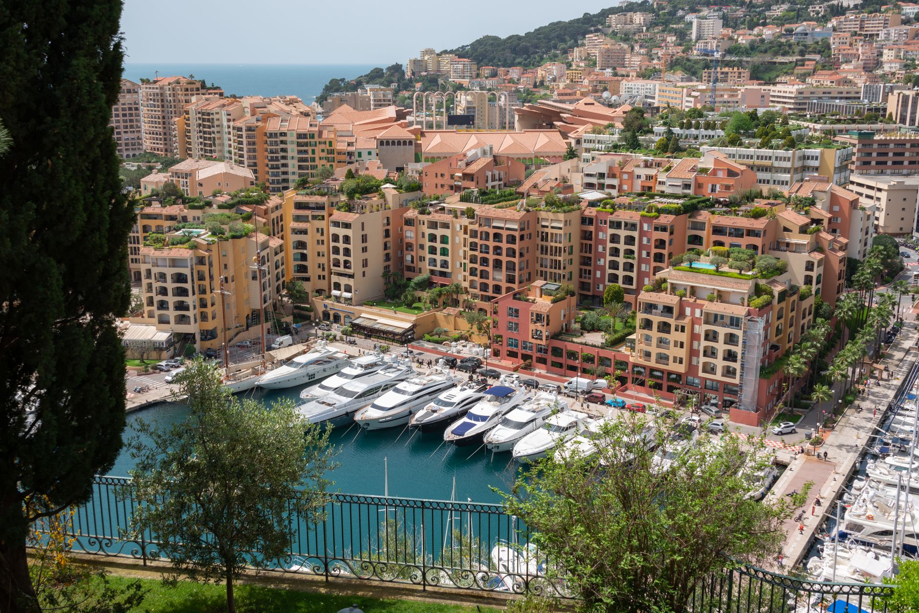 Stunning aerial view of Monte Carlo's marina with yachts and Mediterranean cityscape.