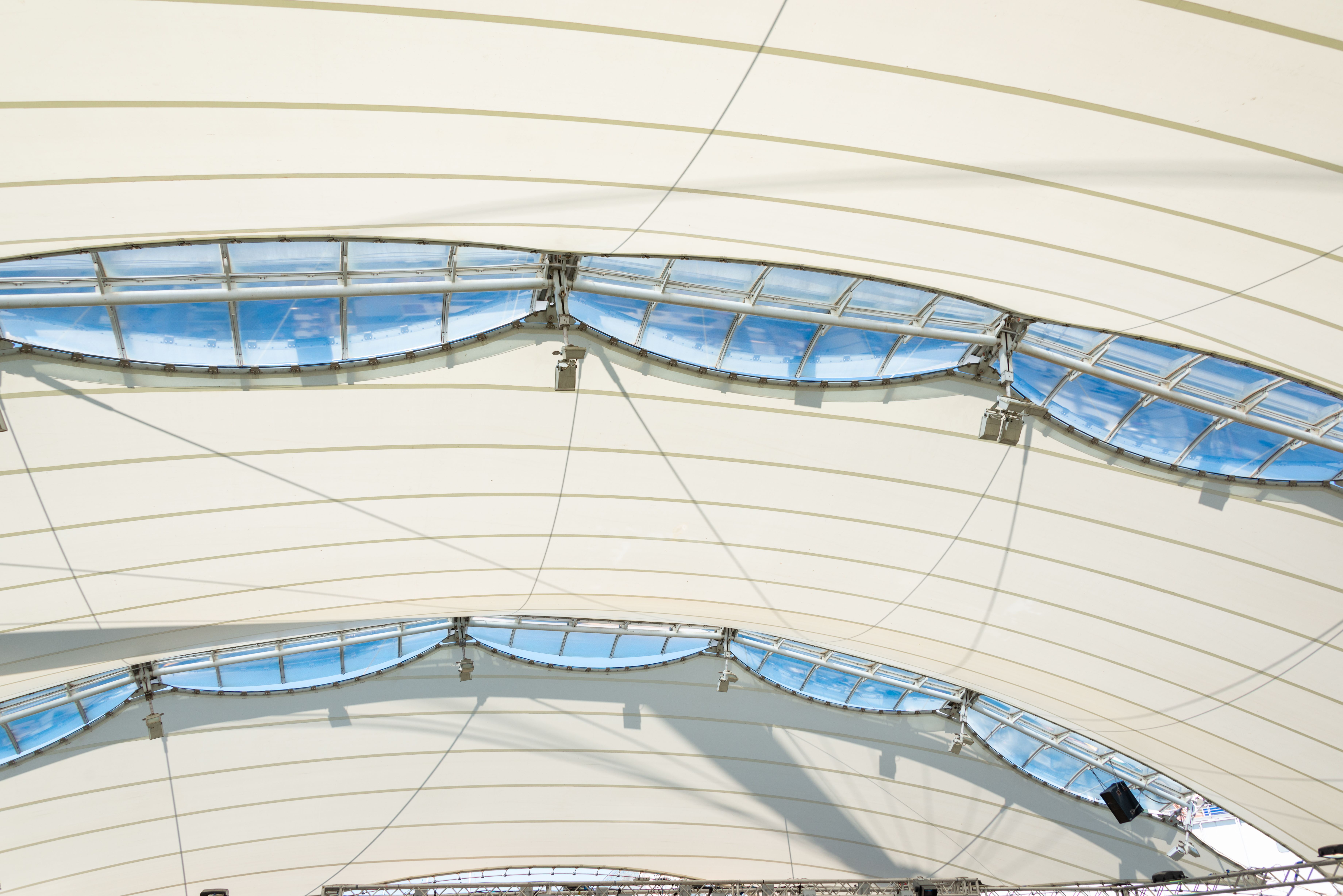 Serene view of a modern rooftop with skylights capturing clear blue skies.