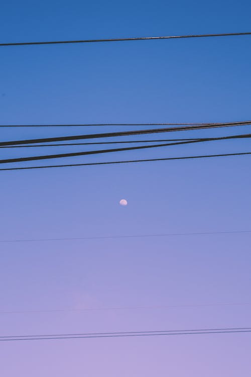 Moon on Sky behind Power Lines