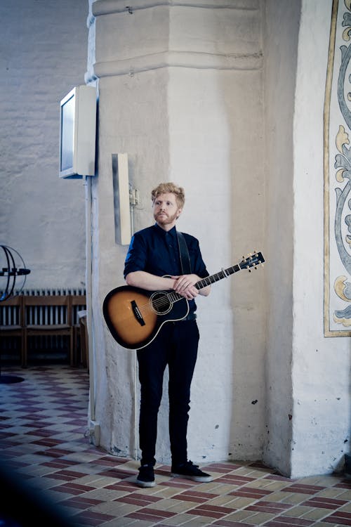 Man Holding Acoustic Guitar