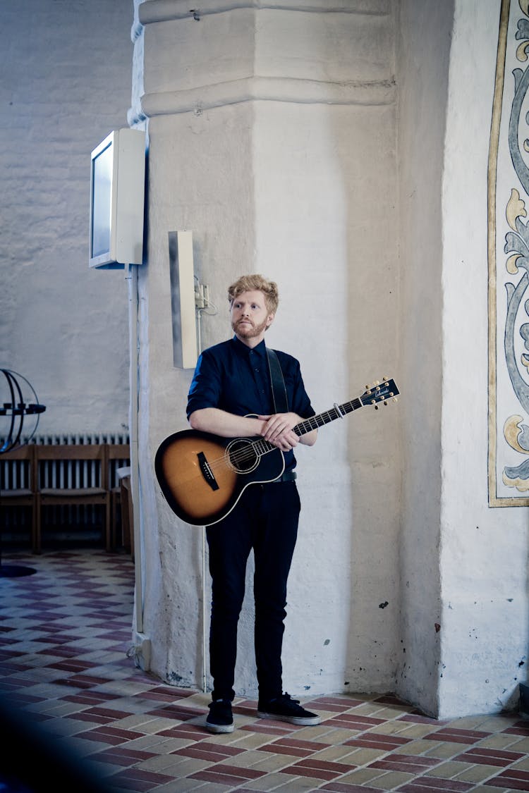 Man Holding Acoustic Guitar