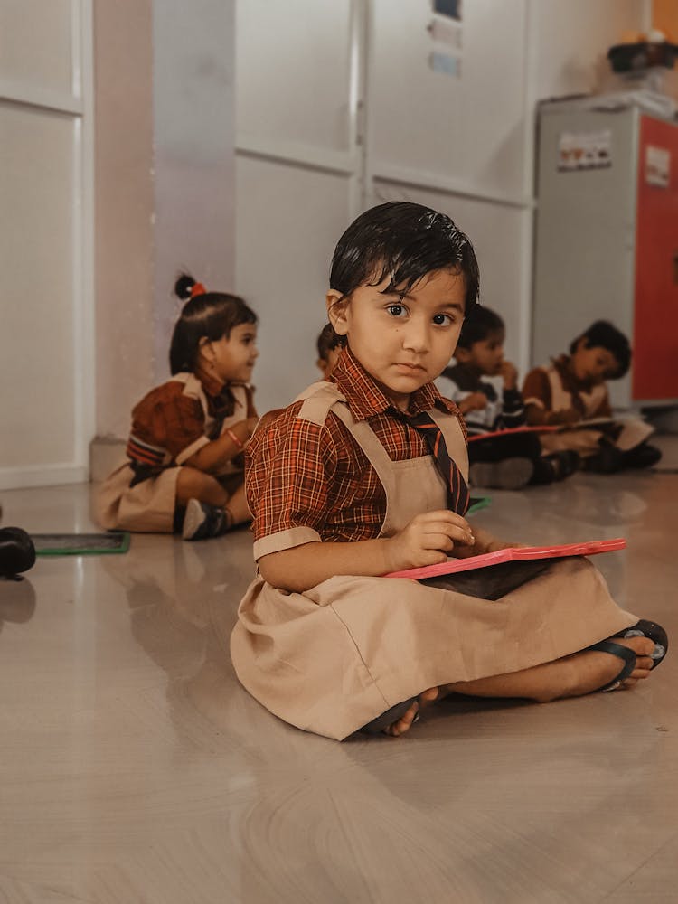 Student Sitting On The Floor