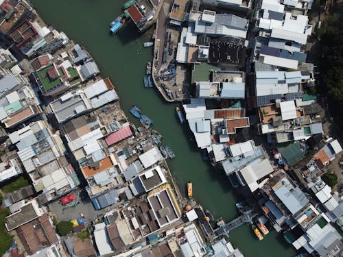 Roofs of Buildings around River in Town