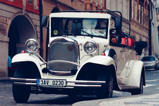 Elegant vintage car on a cobblestone street, capturing timeless charm.