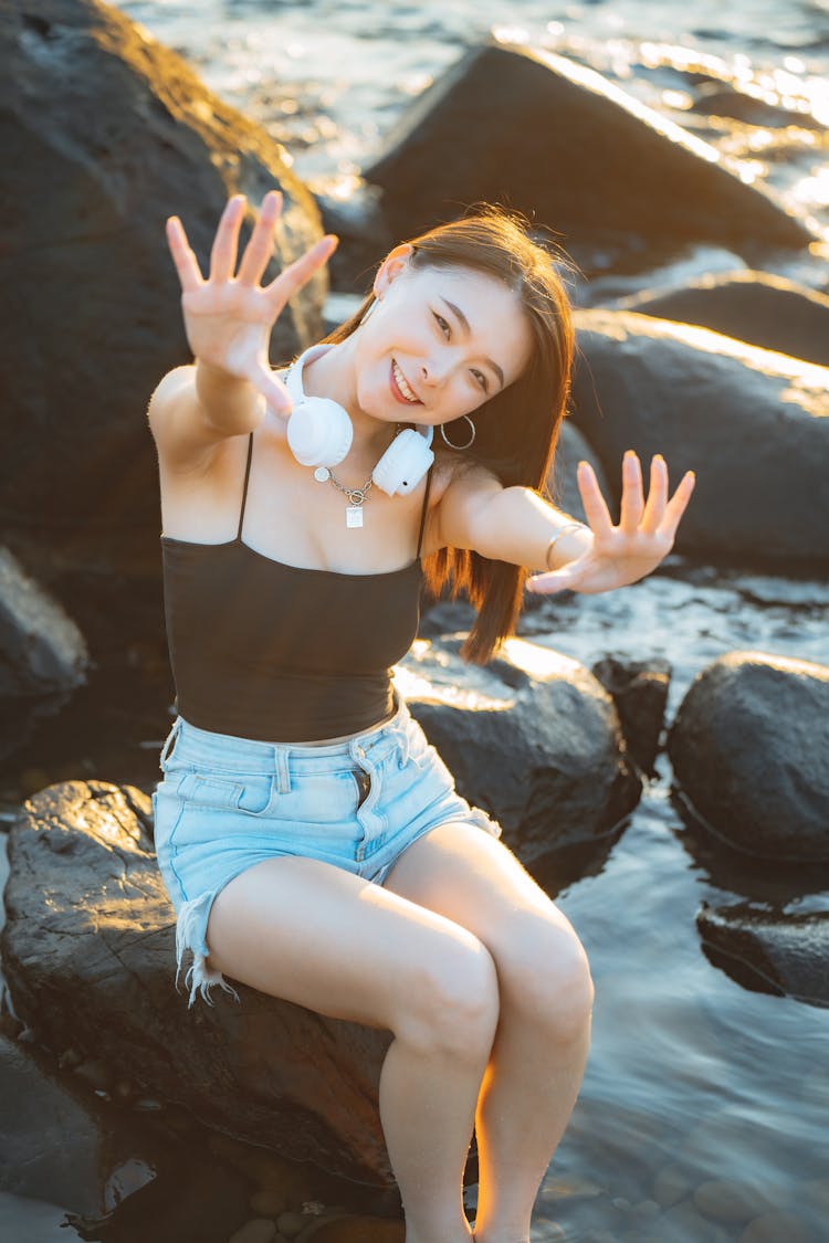 A Woman Smiling While Reaching With Her Hands