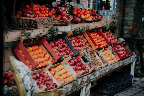 Free Colorful display of assorted fruits neatly arranged in wooden crates at an outdoor market. Stock Photo