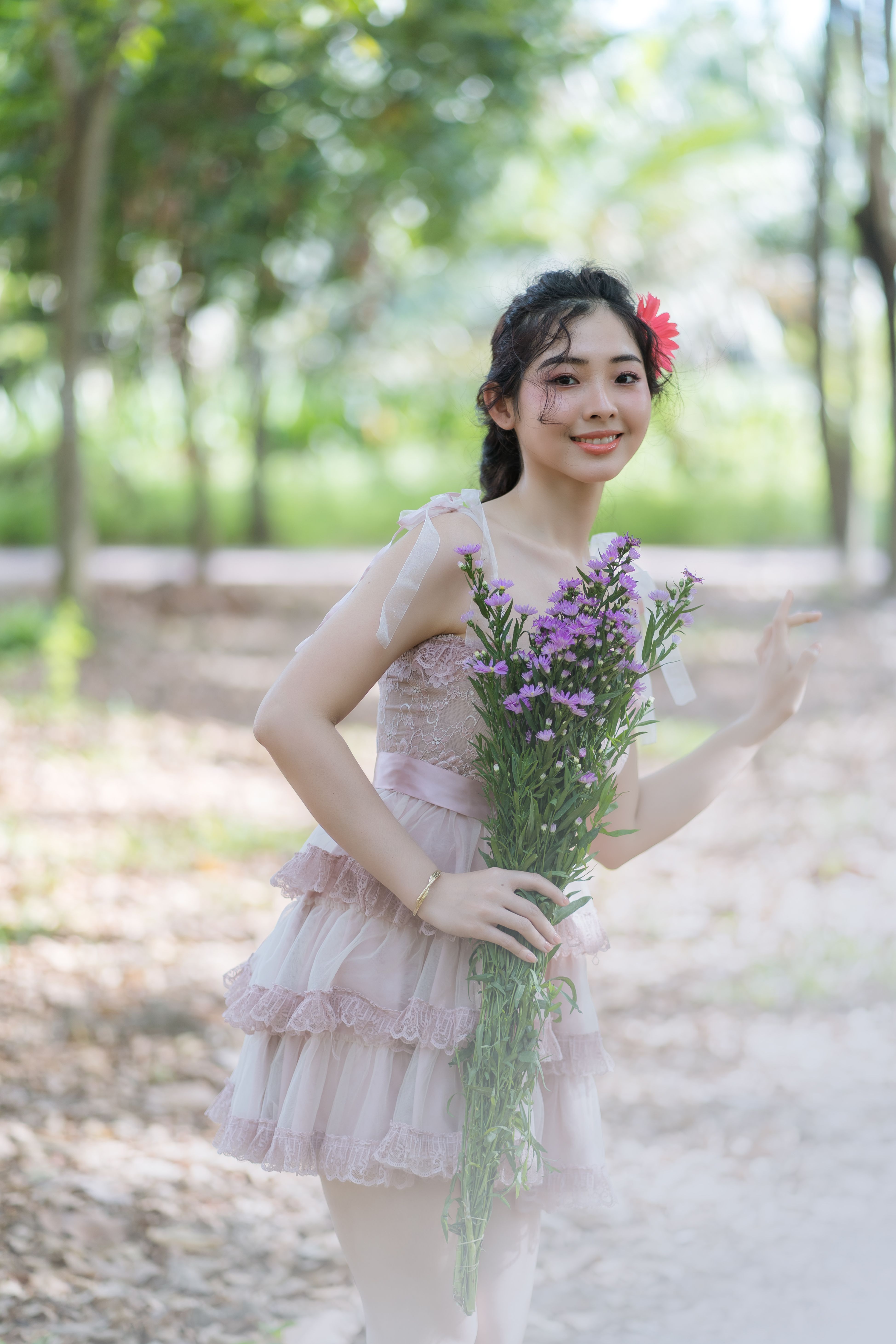 Cute Woman in Dress Kneeling in Park · Free Stock Photo