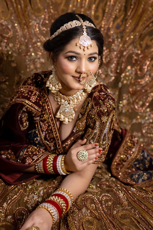 Beautiful Woman with Jewellery in Golden Dress