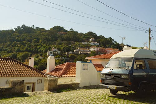 Parked Van Near Concrete House