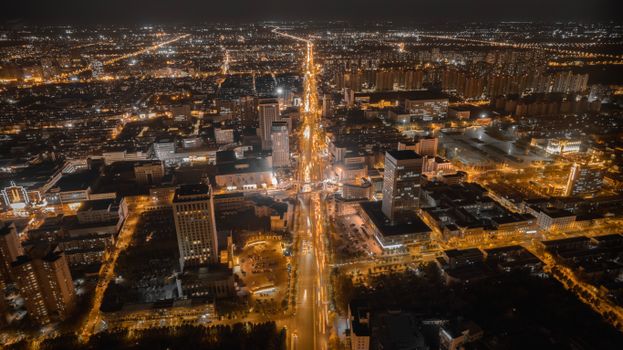 A mesmerizing aerial view of a brightly illuminated cityscape at night.