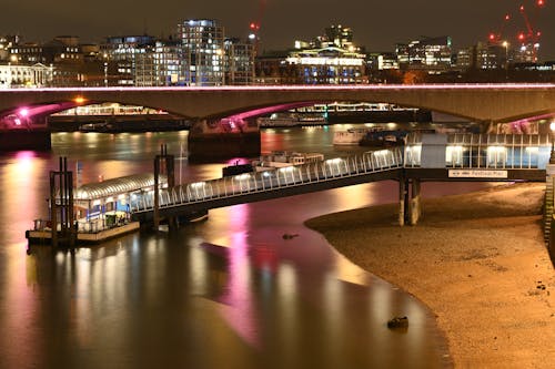 Festival Pier by Waterloo Bridge in London Illuminated at Night