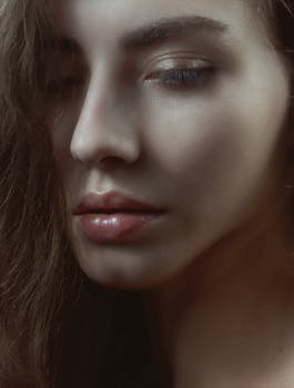 Close-up of a young woman's face in soft natural lighting, conveying calmness and introspection.