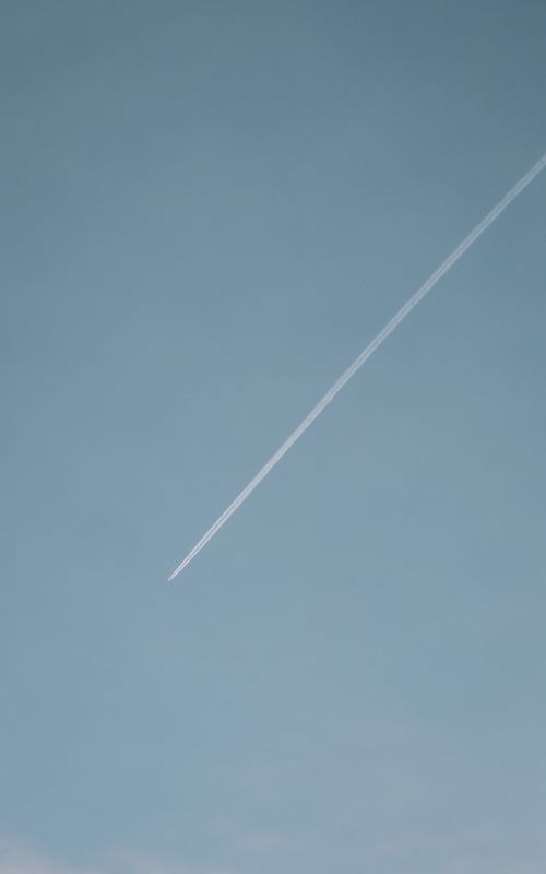 Free A high-altitude jet leaves a contrail streaking across the clear blue sky over Dublin, Ireland. Stock Photo