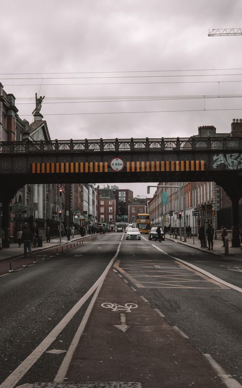 Free Urban scene in Dublin featuring a historic iron bridge and bustling city street. Stock Photo