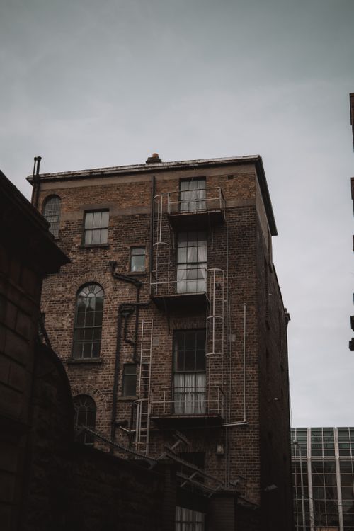 Free Vertical shot of a historic brick building with fire escapes in Dublin, Ireland. Stock Photo