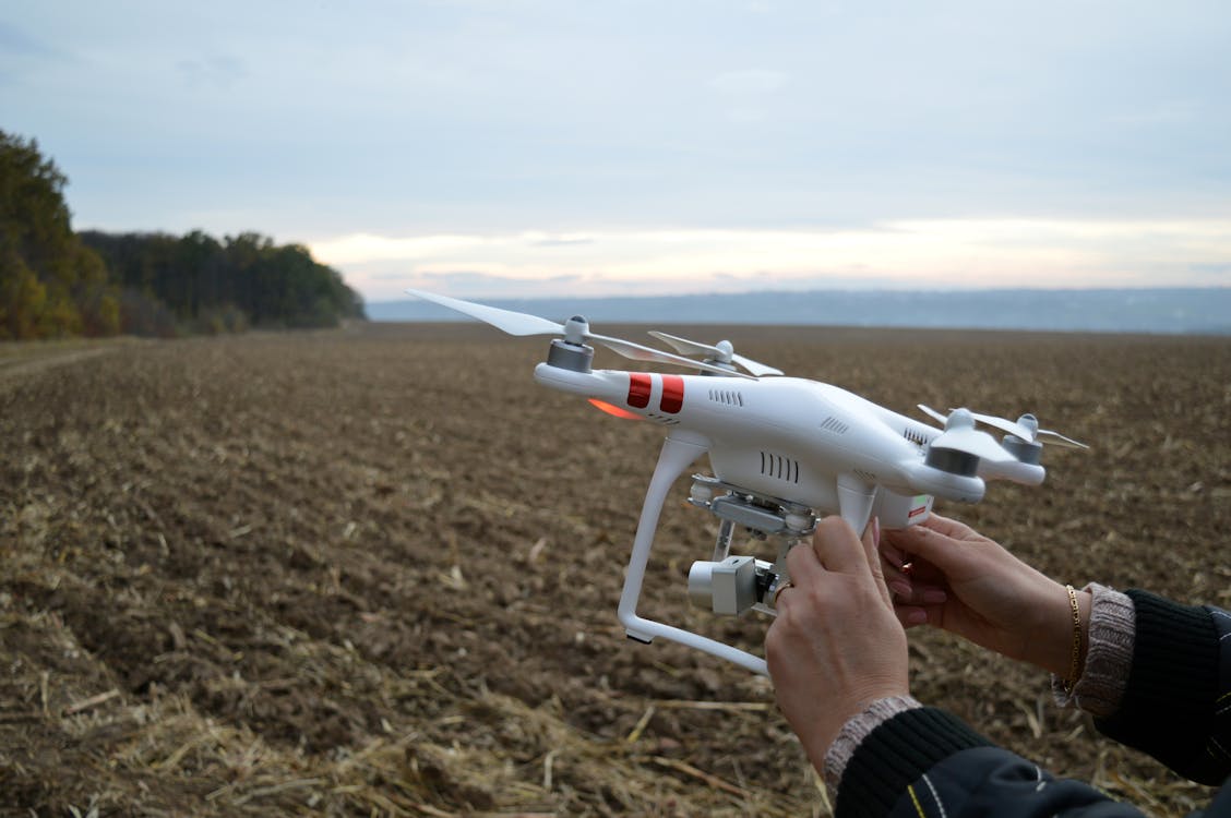 Person Holding Dji Phantom 3 Quadcopter Drone at Open Field