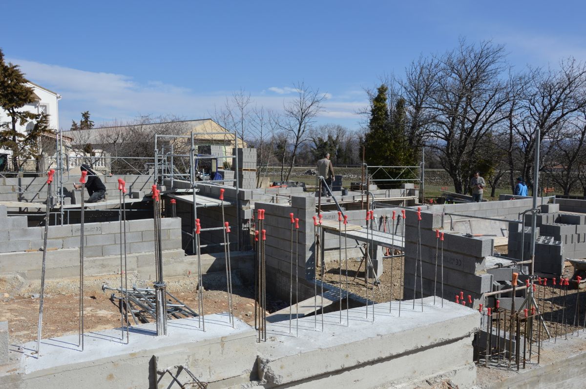 A concrete house foundation on a construction site