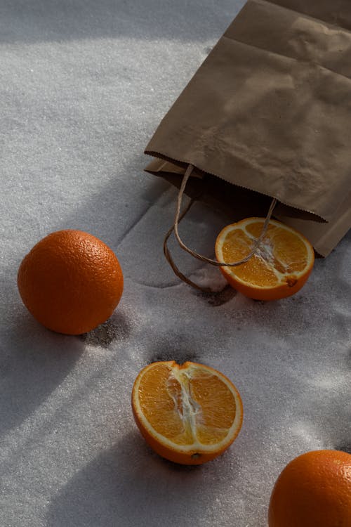 A Sliced Orange Fruit on the Snow