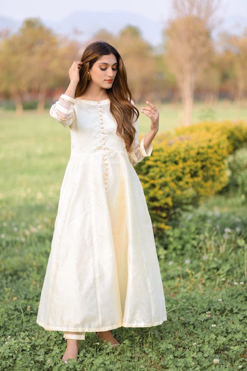 Model Standing in White Dress on Meadow