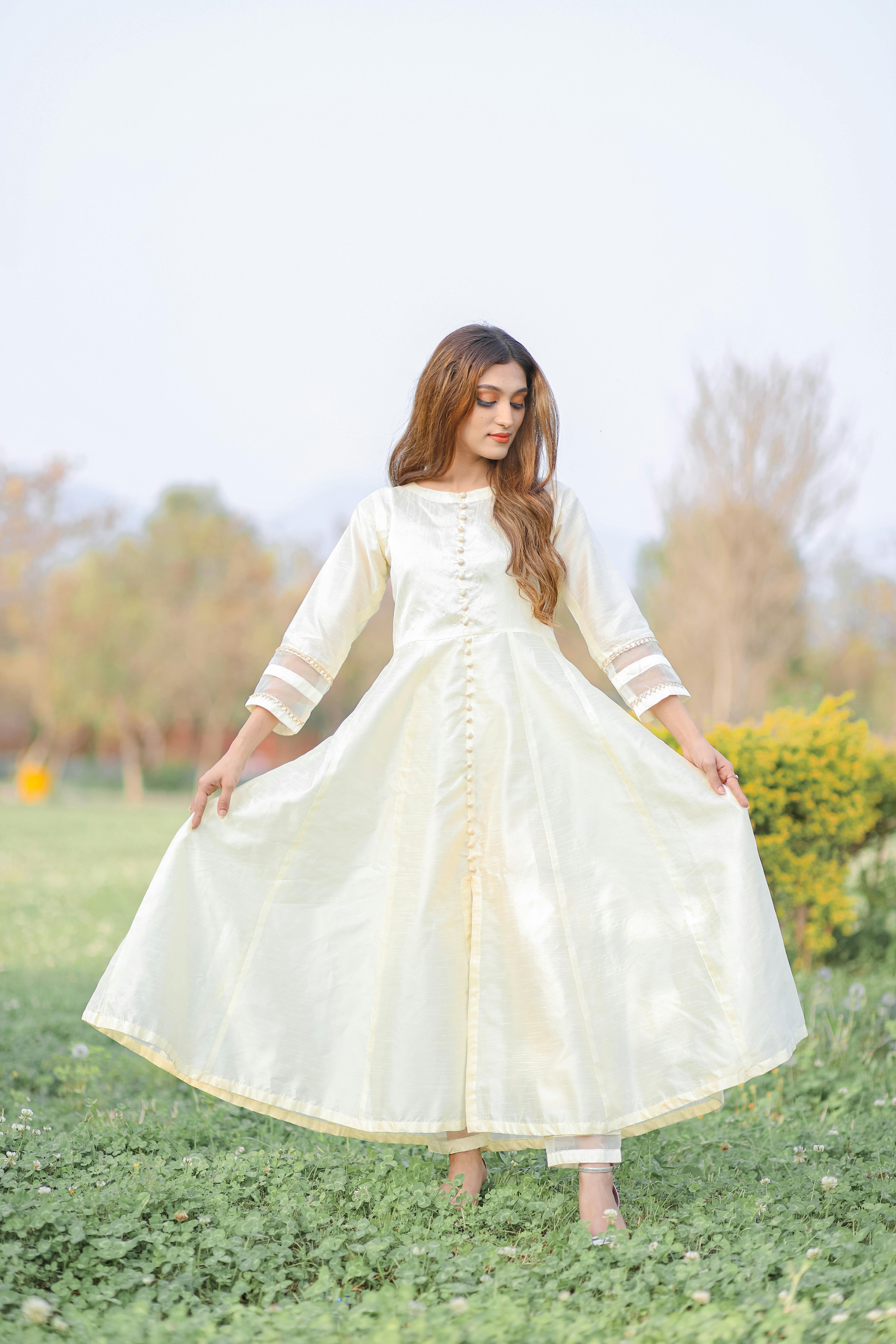 Woman Holding Up Her Lacy Dress Skirt · Free Stock Photo