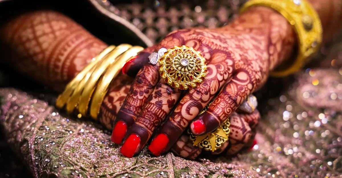 Indian bridal gold jewellery and a legal document, representing a woman's streedhan and her property rights on divorce