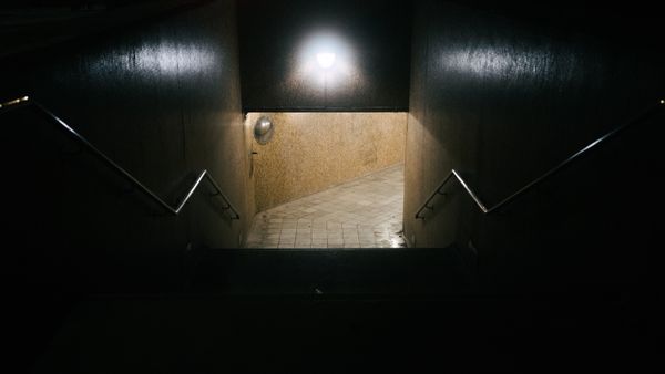 A dimly lit underground staircase — photo by Ryan Morris on Pexels