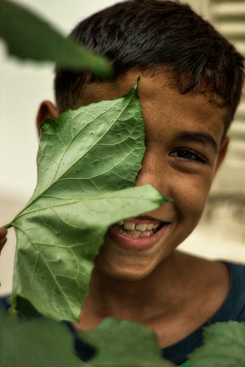 Leaf on Smiling Boy Face