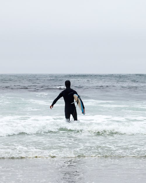 Surfer Entering Sea