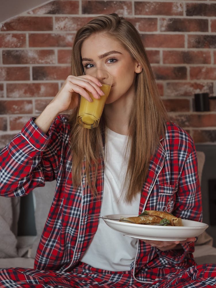 A Woman Drinking Orange Juice