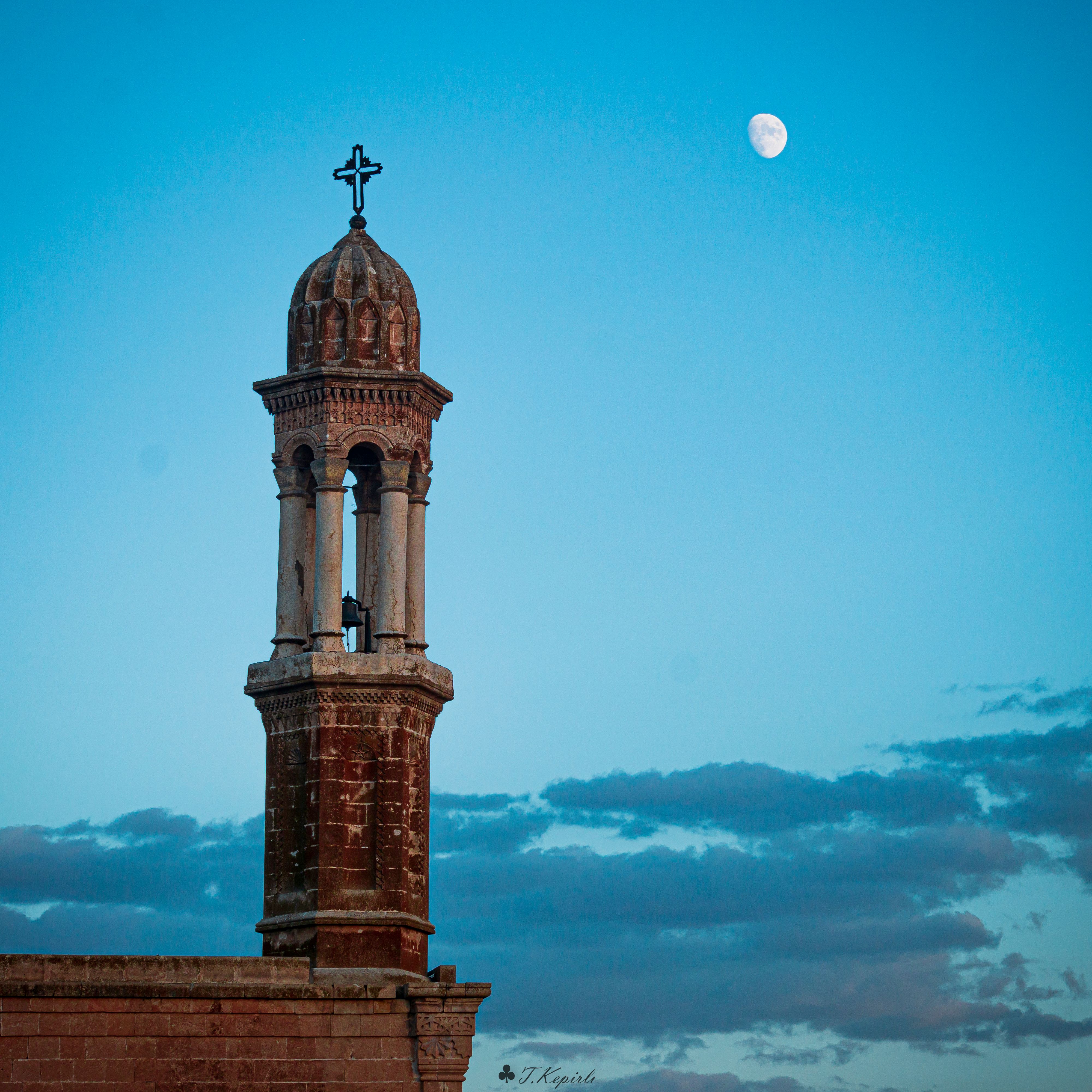 Church Bell Tower against a Blue Sky at Dusk