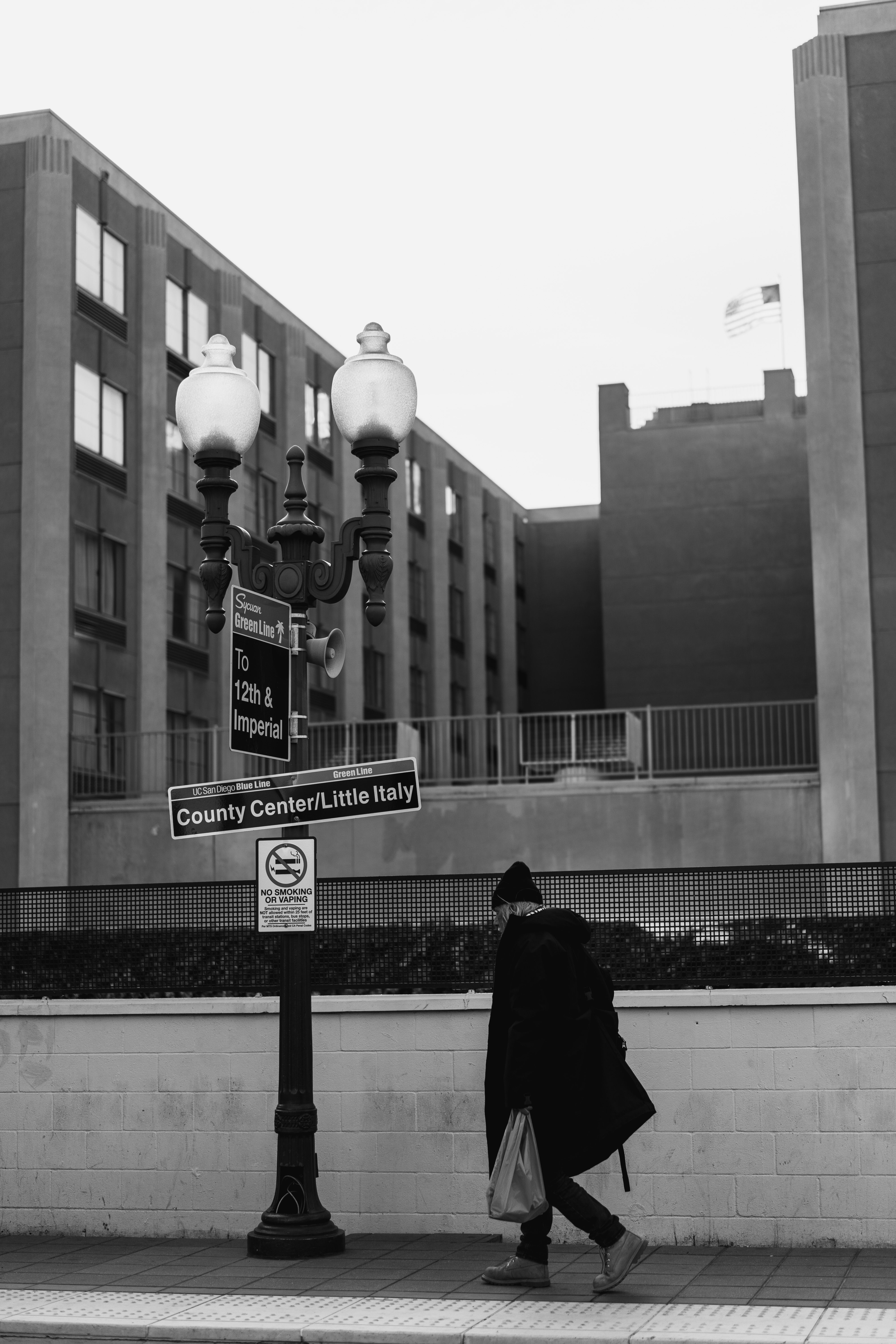 Person Walking on Sidewalk in Black and White · Free Stock Photo