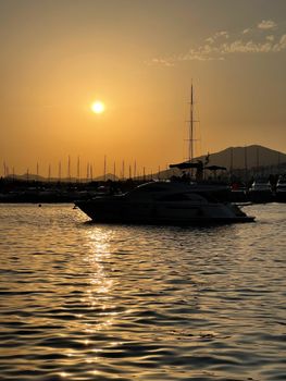 Peaceful sunset view of yachts reflecting on Bodrum waters, Türkiye.